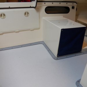 Here is the completed project all closed up.  The big access panel is for the heater.  The new cubby hole helped routing the heating duct and now provides storage.  Two batteries and the kerosene (or diesel) tank are under the passenger seat.  The only evidence of the heater is the thermostat just forward of the cubby hole and just barely visible in front of that is the heat register (outlet) that blows warm air primarily into the V berth.