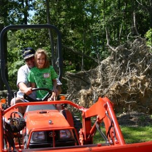 (Otter-BelleHavenMarina) Grace gets a turn on the tractor