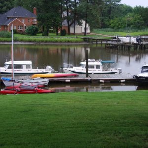 OSPREY\'s dock hosting some of the cruising gang\'s boats. Yes, it was raining.