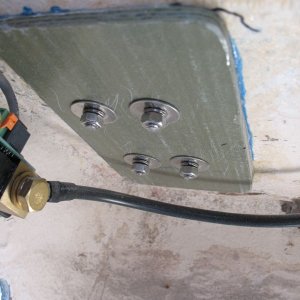 Fiberglass backing plate added to cleat.  First, core removed around fastener perimeters, then re-filled with thickened epoxy (hole in deck not enlarged; work done from below).  Next, backing plate set in place with "mush" of thickened epoxy.  Then holes redrilled through all and cleats re-bedded with butyl tape and re-fastened with new, 316 stainless fasteners.