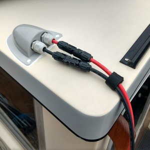 Finished up the cabling/connectors where the panel will connect to the boat. The cables are extension cables going to the panel which is leaning up against the house. When the rack/solar-panel is mounted to the roof the cables directly from the panel will plug right in without the extensions. (I have to leave the rack off for my boat cover to fit).

The velcro strain relief is screwed down under one of the bimini top snaps.