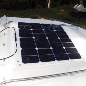 Media 'The panel produces enough amperage to power my little fridge (3.7 amps) without draining the house battery.' in album 'Snads attached to the cabin top.'