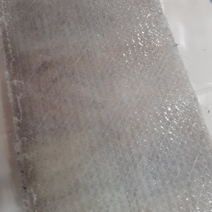 TEST PANEL: 1708 on top, used a fin roller to roll bubbles out.  hard to see voids/ bubbles because the thickened epoxy is kind of milky colored