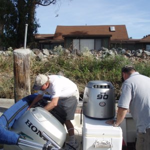 Steve (Dora Jean) doing a little on-the-water maintenance on Dinner Belle II.
