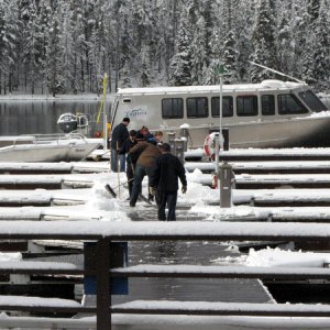 Dock hands cleaning of the docks on the way to the Lake Queen