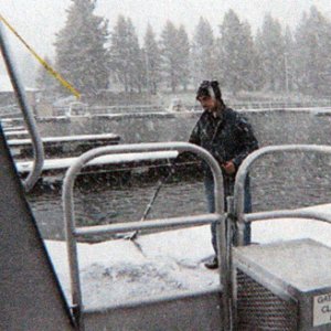 Dockhand, waiting to tie off the stern, in the snow