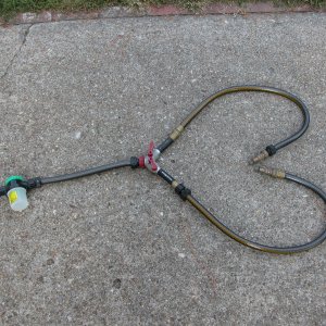 Media 'Flushing setup for use with twin HONDAs saves 20 minutes by doing both engines at once. Parts available at many hardware stores. The two adaptors on the end of the twin hoses are custom HONDA fittings. The Plastic white container is for the "SALT AWAY".' in album 'Flushing setup for use with twin HONDAs. Individual red control handles allow uniform water flow thru each engine as needed.'