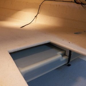 This is about where the tank will sit, pulled up into chocks hung on the underside of the V berth.  The straps that will suspend the tank have stainless buckles and are adjustable, which is important as the tank actually changes size depending on temperature and fill.  Upper corner at right is where the fill and vent tubes come through the berth platform headed to the new deck fitting.