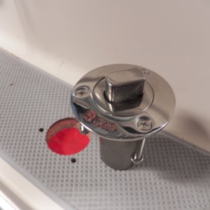 Here is the gas fill hole.  It is now taped and ready for epoxy putty to cover the exposed balsa and allow the fastenings to pass though epoxy rather than balsa.  Where's that darn deck key??  Oh yeah, I don't need one for this gas fill!  The turning tab pops up from its flush position.