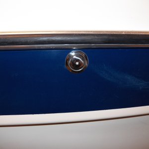 The tank vent goes under the rub rail.  If above the rub rail, any leak (which never happens) is spread all along the rail.