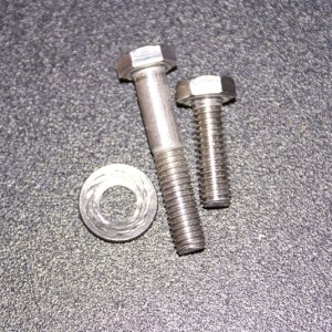 Helm Seat - Slider bolts.  These are from the "corrected" second shipment of the seat.  The one longer bolt was wedged in the apparently re-drilled and stripped hole in the seat.  See next photo.