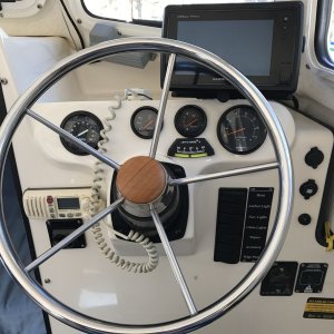 Helm station with Garmin 741xs chartplotter/sounder, FlowScan gph meter, voltmeter, engine tit and trim gauge, multi function tachometer gauge, Lev-O-Gage, Icom VHF radio, trim tab controls, rocker switches and two 12 volt cigarette adapters.