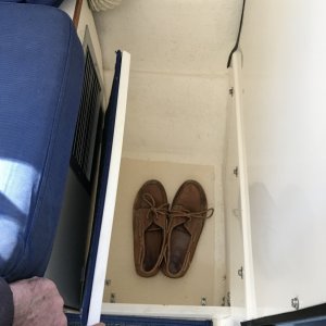 Starboard foot locker in front of passenger seat.