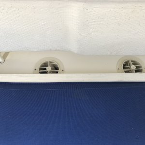Air conditioner vents behind port bench seat.