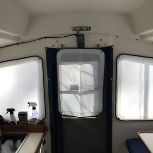 Translucent window covers for all windows and full length zippered screen in doorway.