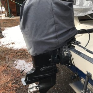 Covered Suzuki DF 90 outboard engine.