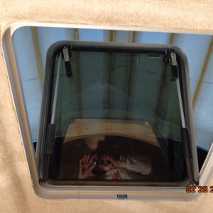 Getting the hull liner fitted around the hatch in the V-berth.
