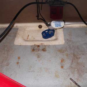 I removed all the junk.  The holes were then coated with penetrating epoxy, left for 24 hours, then filled with an epoxy putty made from wood dust, then painted again with penetrating epoxy.  The bilge pump base was screwed and glued in place.  I tore it out, which ruined the base ($8) and will just glue it back in place to eliminate any penetration into the balsa core.