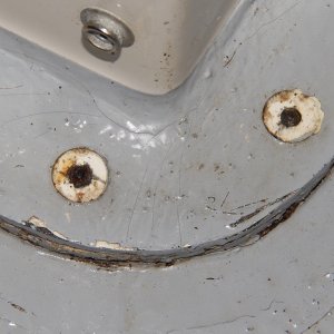 Here are the holes that concerned me next.  The seat box/cockpit liners are fastened to the deck with blind rivets.  Do these go into the balsa core?  Yikes!  The rivet heads have popped off and the caulking has failed.  Not a good sign if these go into the balsa core.