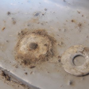 Even the rivets that looked good simply fell apart when bumped or drilled.  These are aluminum rivets with a steel mandrel.  Not a problem if they never get wet.  Oh that's right, it's a boat!