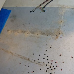 This is a good picture of the most extensive damage.  The dark holes on the port side indicate rotten wood where the seat box pop rivets leaked the most.  I have left the swarf from the drilled out rivet holes on the starboard helm seat.  You can see by the color of the swarf that the wood is good and gets better towards the bow.  The V berth support posts were also removed (both good, but need reinforcement because of my new permanent gas tank).