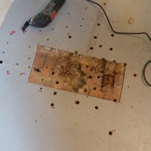 Here is what removing the top laminate revealed after I cut it off with a little circular saw.  There is a rotten area right in the center caused by several leaking pop rivets right at the aft corner of the seat box.  What I had suspected is that the leak migrated towards the center of the boat.  You can see that balsa does not rot uniformly, meaning that some pieces in the parquet have rotted while others simply discolored.  The dark rectangle on the right side of the cutout was completely saturated and rotten while some of the surrounding wood was almost dry. To the left of the cutout is another dark hole that was bad.  I will have to expand the cutout to include that area.