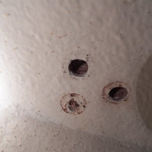 The hole closest to the hull had to be drilled out from above.  This shows the mildew/rust that was likely caused by water in the balsa deck, not condensation on the interior.