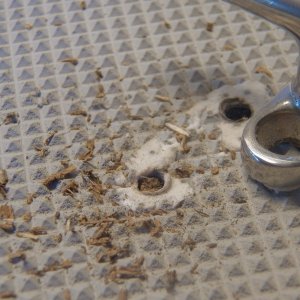 Here was one of the leaks.  The cleat was set in silicon bath tub caulk, which can work okay if there is no pressure placed on the fitting.  Wait a minute.  Oh yeah, it's a cleat.  This will have to be bored out and filled with epoxy.  I found that a "file card brush" was aggressive enough to remove the caulk and not damage the deck.