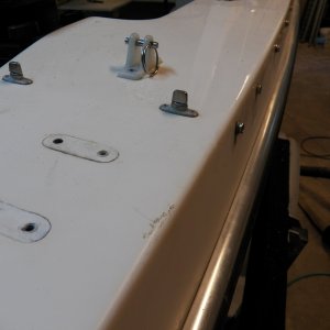 So far, every deck penetration that could be done wrong was done wrong.  I found that the little snap fittings for the bimini had been pop riveted (and many had failed because of using aluminum with stainless).  Those that had been replaced over the years also had leaked.  All have now been removed.  I only found a couple of bad spots in the balsa core, and those appeared to be discolored rather than rotten.  Again, with the balsa core moisture at full saturation, it is difficult to identify exactly what was leaking.  I didn't find anything that made me want to tear off the fiberglass laminate (from below) and examine, but then I'm also really reluctant to go there.