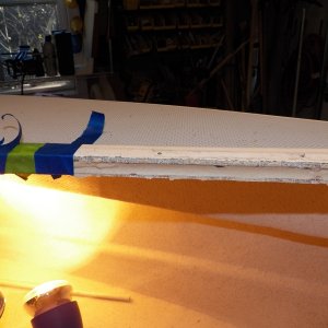 The tape is being removed to show the hardened putty.  The putty goes in over 1 inch, allowing the mounting screws for the hatch to now go into the epoxy rather than the balsa core.  The heat lamps are still being used on the little side deck where the pulpit and cleats have allowed water in.  I had to drill additional holes from underneath to let the moisture out and monitor the drying process.