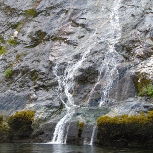 Media 'Whispering Falls, half mild or so from Chatterbox.  We sat and listend to the quiet water-whjispers for several minutes.  Even smelled good.' in album 'B-Boat 22, the Julie Anne, running with us up to Princes Louisa Inlet.  Flat here but we did see WOW(Waves On Water)! and lots of rain. C-Dory used 1/2 the fuel at every stop.'
