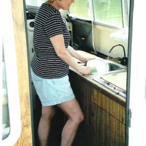 Anne can use her knee to turn water on for two handed dish washing.