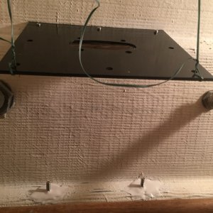 View of bracket bolts beneath mounting plate
