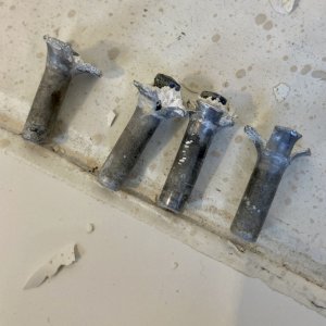 Once I identified the ones that were defective and removed the gob on the inside it was just a matter of pushing out the body of the rivets from the outside to expose each hole