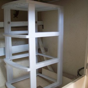 The frame of this cheap Sterilite drawer system is screwed to the top shelf.