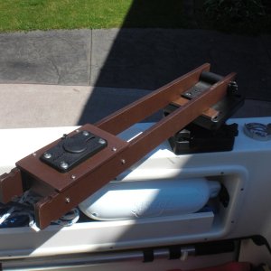Swings inboard.  You then hook up the BBQ and gas cylinder.  If you drop anything, it stays in the boat.