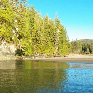 The mouth of the Battle River is against the rock on the left.  A large sand spit (shown here as the glassy area) extends out on an otherwise easily approached beach.