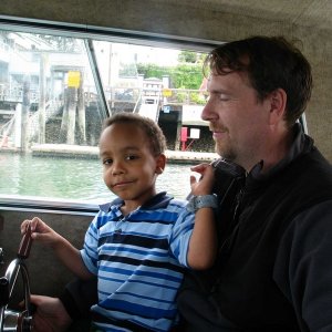 Jim and Wadi pilot the boat