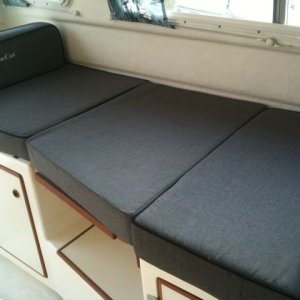 A cushion I had made to fit the oddly shaped table. More comfortable for sleeping and sitting than the supplied rectangular cushion!