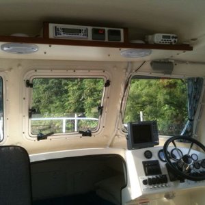 A view of the helm and electronics shelf. The two meters adjacent to the stereo are Blue Sea volt/ammeters wired directly to the batteries.