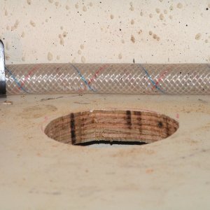 (Dora~Jean) Access hole for tubing to resevoir and air return.