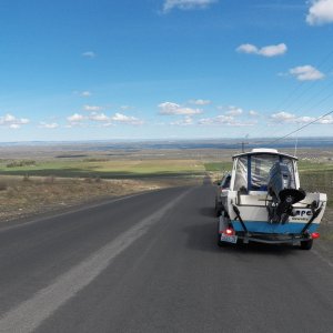 Media 'Driving down into the Frenchman Hills area with Moses Lake over the boat cabin.' in album 'Off to the Potholes.  This is driving past Soap Lake.'