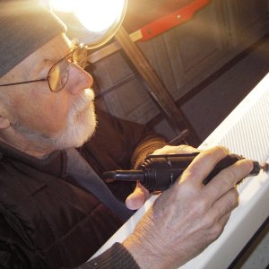 Neighbor Paul, dremeling out the cracked jell coat where the step plate screws broke out.