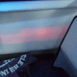 Maybe you CAN shine a flashlight from the outside and see it inside!  I think the coloring is actually from the red light on the portside exterior--odd looking, eh?