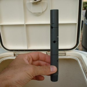 This plastic tube screws into a fitting on the bottom of the tank. The tube is drilled to allow water to drain slowly and prevents small bait from being sucked down the drain.