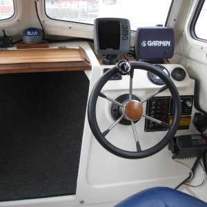 Moved the VHF Radio to lower right of the helm and installed compass in the top center.