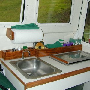 Teak storage behind stove and sink, for CD's, spices, tissues, camera's, etc.