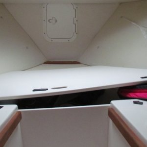 Media 'the anchor locker is the vertical hatch straight ahead in the middle.The whole front horizantal lid left ajar for this picture and can be completely removed to access storage area' in album 'the smaller hatch on the port side is where my wife stores her clothes and starboard side is where I keep my clothes.Black spots are velcro for trying to keep cushions in place'