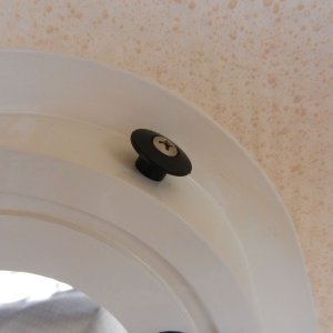 I used a kayak "bungee button" 

(http://kayakfishinggear.com/bungeebutton.aspx) 

at each corner of the window frame.