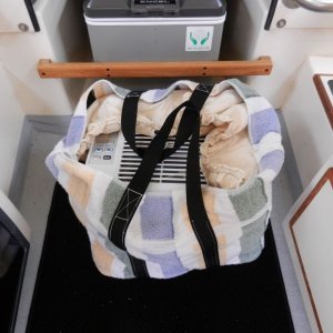 Media 'Lisa also made a great stow bag with a semi-rigid rubberized bottom for schlepping the thing around the boat.' in album 'The first thing I did was epoxy some "feet" on the bottom of the AC.  There are "hooks" cut into the feet to sit on the window frame.  These are glued down with 5200.'